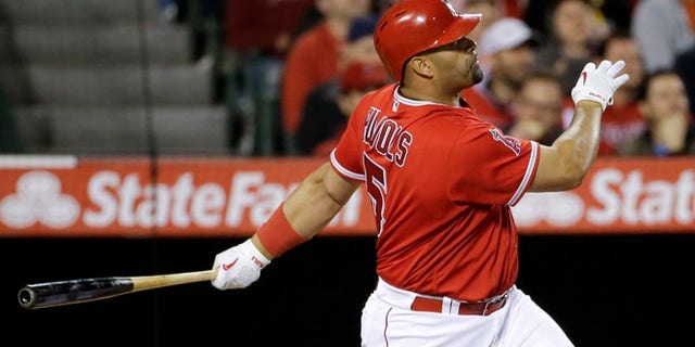 Los Angeles Angels' Albert Pujols watches his home run against the Kansas City Royals during the fifth inning of a baseball game in Anaheim, Calif., Monday, April 25, 2016. (AP Photo/Chris Carlson)