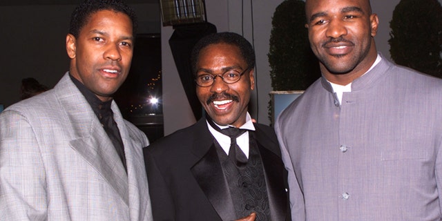 Dec. 14, 1999: Actor Denzel Wahington (L), star of the film "The Hurricane," based on the true story of Rubin "Hurricane" Carter (C), an innocent man who fought for 20 years for justice, poses at the film's premiere party in Los Angeles with boxing champion Evander Holyfield.