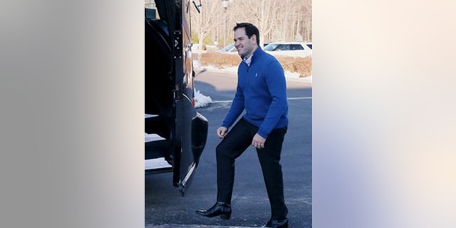 Republican presidential candidate Sen. Marco Rubio, R-Fla., steps into his campaign bus after a stop at the Atkinson Country Club, Sunday, Jan. 3, 2016, in Atkinson, N.H. (AP Photo/Mary Schwalm)