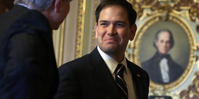 U.S. Senator Marco Rubio with colleague John Hoeven on November 19, 2013 on Capitol Hill.