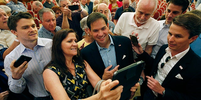Republican presidential candidate Sen. Marco Rubio, R-Fla., takes pictures with people during a campaign event Saturday, July 11, 2015, in Henderson, Nev. (AP Photo/John Locher)