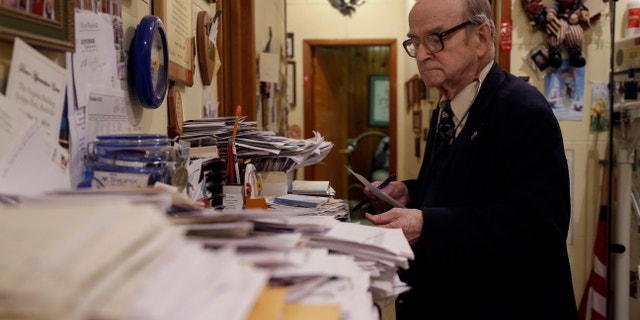 Oct. 30, 2012: Dr. Russell Dohner looks over paper records between seeing patients in Rushville, Ill. (Jeff Roberson/AP)