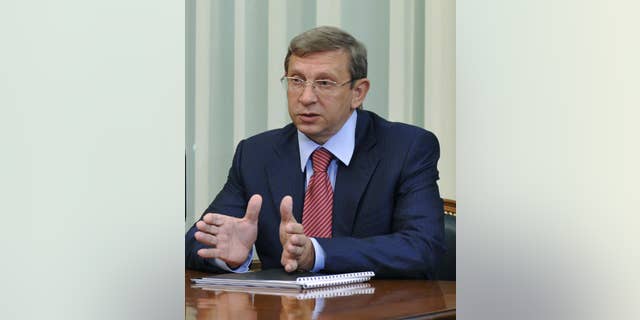 FILE- In this Tuesday, May 5, 2009 file photo Russian tycoon Vladimir Yevtushenkov, owner of Sistema Holding, speaks during a meeting with then Russian Prime Minister Vladimir Putin in Moscow, Russia. The arrest of the Russian billionaire has sent shares in his holding company into a tailspin Wednesday morning, Sept. 17, 2014. Yevtushenkov, who is worth $9 billion according to the Russian Forbes magazine, was placed under house arrest late Tuesday, Sept. 16, in a money-laundering case which has drawn comparisons with a government crackdown on the Yukos oil company more than a decade ago. (AP Photo/RIA Novosti, Alexei Druzhinin, Presidential Press Service, File)