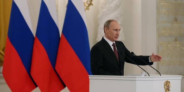 Russia's President Vladimir Putin addresses the Federation Council in Moscow's Kremlin on Tuesday, March 18, 2014. President Vladimir Putin defended Russia’s move to annex Crimea, saying that the rights of ethnic Russians have been abused by the Ukrainian government. He pointed at the example of Kosovo’s independence bid supported by the West, and said that Crimea’s secession from Ukraine repeated Ukraine’s own secession from the Soviet Union in 1991. (AP Photo/Sergei Ilnitsky, pool)