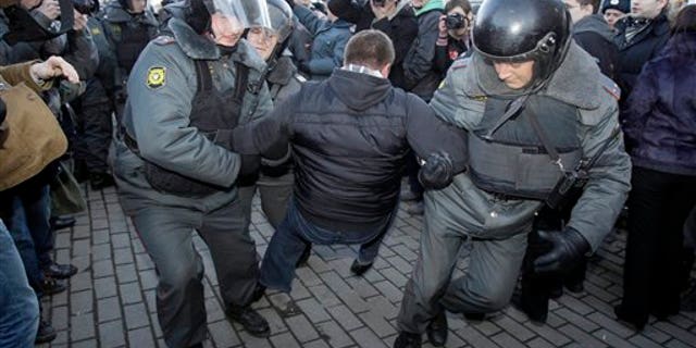 March 31: Riot police officers detain a demonstrator during an unauthorized rally at the Triumfalnaya Square  in Moscow. Riot police in Moscow have forcefully detained about 25 protesters who unfurled an anti-government banner at an unauthorized demonstration. Thursday's demonstration was the latest in a series of actions that Russian opposition figures call at the end of every month with 31 days. The number corresponds with Article 31 of the Russian Constitution, which guarantees freedom of assembly. (AP)