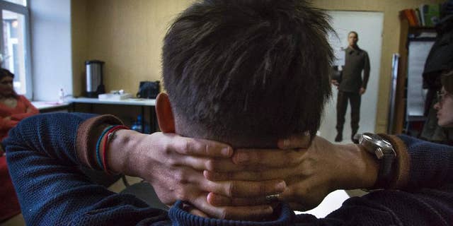 In this photo taken on Tuesday, Feb. 17, 2015, Alevtina sits in LGBT rights group Vykhod center in St. Petersburg, Russia. Alevtina is one of several teachers who lost their jobs in St. Petersburg after being outed by an anti-gay activist. While most resigned quietly, the 27-year-old music teacher decided to fight her dismissal in court _ an unusual step in Russia where gays have faced increasing pressure in recent years. (AP Photo/Dmitry Lovetsky)