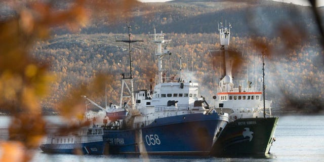 October 1, 2013: In this image made available by Greenpeace, the Greenpeace ship, the Arctic Sunrise, right, is anchored side by side with the Russian Coast Guard Ship in the Kolskii gulf, near Murmansk, Russia on Monday, Sept. 30, 2013. (AP Photo)