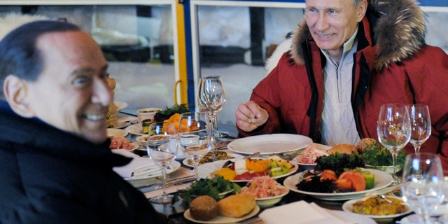 Mar. 7, 2012: Former Italian Prime Minister Silvio Berlusconi, left, and Russian Prime Minister Vladimir Putin, right, smile during their meeting in the mountain resort of Krasnaya Polyana near the Black Sea resort of Sochi, southern Russia.