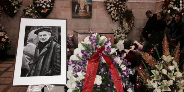 People mourn Andrei Mironov who was killed during fighting in eastern Ukraine, at a memorial service in Moscow, Friday, May 30, 2014. The translator, 60-year-old Andrei Mironov, died along with Italian photographer Andrea Rocchelli, was mourned at his funeral in Moscow on Friday. One of the last political prisoners to be held during the Soviet era, Mironov dedicated the rest of his life to exposing human rights abuses. He also helped foreign journalists covering war and injustice to bring those stories to the world. (AP Photo/Lynn Berry)