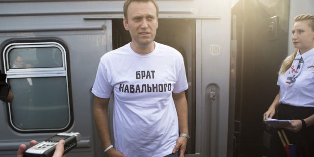 July 17, 2013: Russian opposition activist Alexei Navalny, wearing a T-shirt reading "Navalny's Brother" speaks to supporters and the media at the Yaroslavsky railway terminal in Moscow. (AP Photo/Alexander Zemlianichenko Jr)