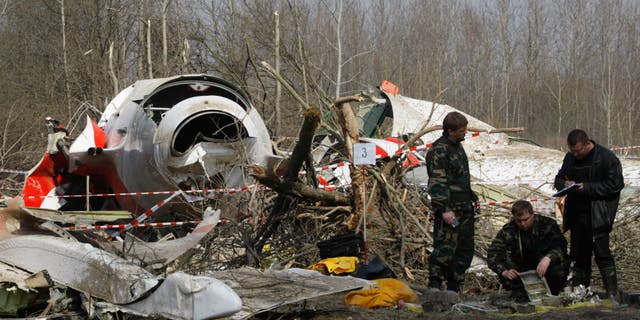 April 11, 2010: Russian investigators work near the wreckage of the Polish presidential plane, that crashed just outside the Smolensk airport in Russia. Russian officials investigating the airplane crash that killed Polish President Lech Kaczynski have now released a report that places the blame on the Poles alone.