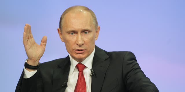 Dec. 16: Russia's Prime Minister Vladimir Putin gestures during a call-in session live broadcast.