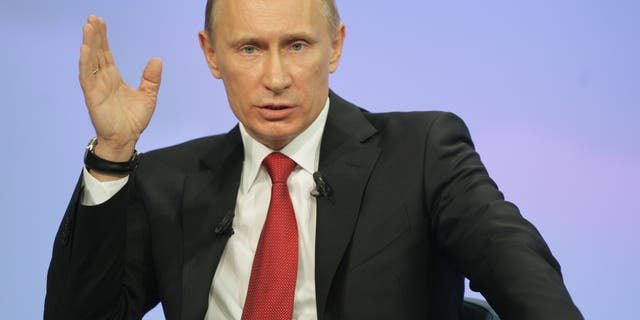 Dec. 16: Russia's Prime Minister Vladimir Putin gestures during a call-in session live broadcast.