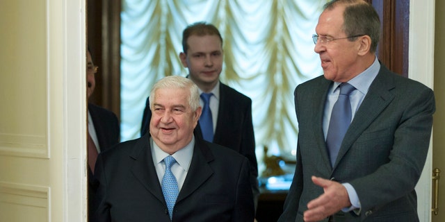 Jan. 17, 2014 - Russian Foreign Minister Sergey Lavrov, right, and his Syrian counterpart Walid al-Moallem arrive for talks in Moscow, Russia, on Syria. Foreign Minister said Friday that his country is prepared to implement a cease-fire in the war-torn city of Aleppo and exchange detainees with the country's opposition forces.