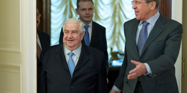 Jan. 17, 2014 - Russian Foreign Minister Sergey Lavrov, right, and his Syrian counterpart Walid al-Moallem arrive for talks in Moscow, Russia, on Syria. Foreign Minister said Friday that his country is prepared to implement a cease-fire in the war-torn city of Aleppo and exchange detainees with the country's opposition forces.