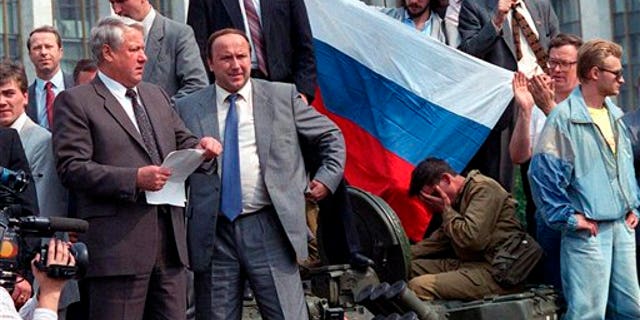 Aug. 19, 1991: Boris Yeltsin, president of Russian Federation, left, reads a statement from atop a tank in Moscow as he urges the Russian people to resist a hardline takeover of the central government.