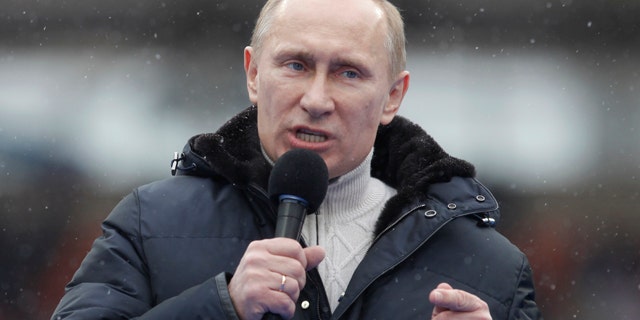 Russian Prime Minister Vladimir Putin attends a massive rally in his support at Luzhniki stadium in Moscow, Feb. 23, 2022.