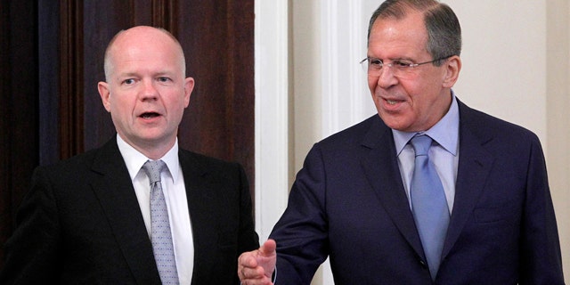 May 28: Russian Foreign Minister Sergey Lavrov, right, welcomes his British counterpart William Hague during their meeting in Moscow, Russia.