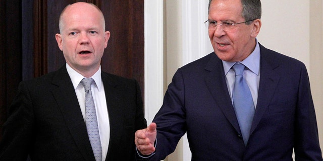 May 28: Russian Foreign Minister Sergey Lavrov, right, welcomes his British counterpart William Hague during their meeting in Moscow, Russia.