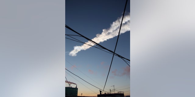 The trail of a falling object is seen above the Urals city of Chelyabinsk, in this view from a residential apartment February 15, 2013.
