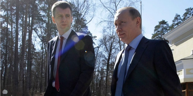 April 2011: Russian Prime Minister Vladimir Putin, right, flanked by Russian billionaire Mikhail Prokhorov at the Gorki residence outside Moscow.