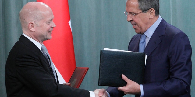 May 27, 2012: Russian Foreign Minister Sergey Lavrov, right, and his British counterpart William Hague shake hands as they exchange documents after their meeting in Moscow, Russia.