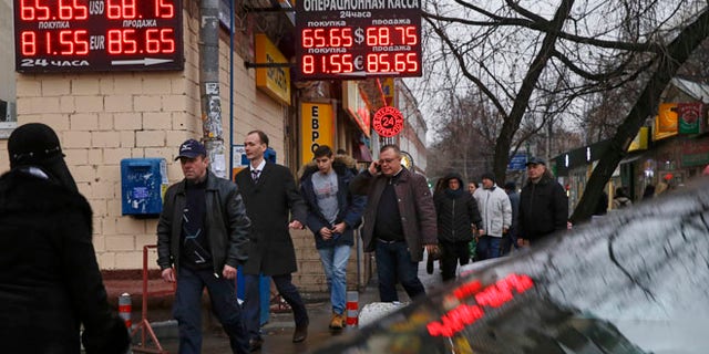 Dec. 16, 2014: Signs advertising currencies are illuminated next to the exchange office in Moscow, Russia.
