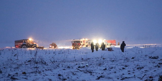 In this photo provided by the Russian Emergency Situations Ministry, Russian Ministry for Emergency Situations employees work at the scene of a AN-148 plane crash in Stepanovskoye village, about 25 miles from the Domodedovo airport, Russia, Sunday, Feb. 11, 2018.