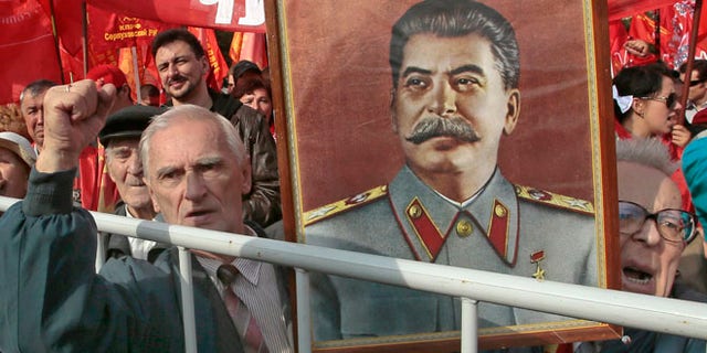 Sept. 22, 2012: Russian Communist Party supporters hold a portrait of former Soviet dictator Josef Stalin at a gathering in Moscow to protest increasing prices for communal services.
