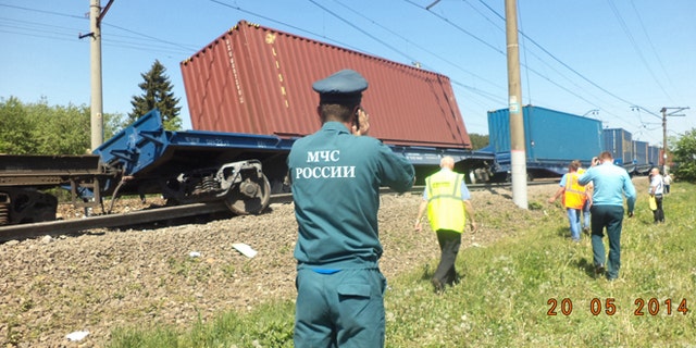 May 20, 2014: A ministry employee uses a mobile phone at the site of train collision near the city of Naro-Fominsk outside Moscow.  (AP/ Ministry for Emergency Situations Press Service)