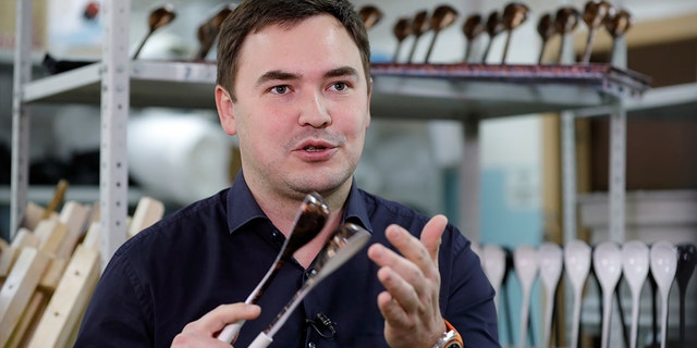 Designer Rustam Nugmanov plays spoons branded "Spoons of Victory", the official instrument chosen by Russia for the 2018 FIFA World Cup.