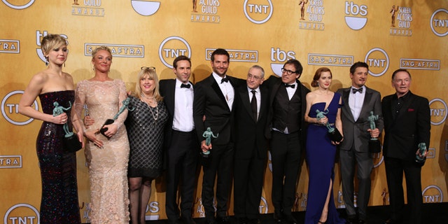 From left, Jennifer Lawrence, Elisabeth Rohm, Colleen Camp, Alessandro Nivola, Bradley Cooper, Robert De Niro, David O. Russell, Amy Adams, Jeremy Renner and Paul Herman pose in the press room with the award for outstanding performance by a cast in a motion picture for âAmerican Hustleâ at the 20th annual Screen Actors Guild Awards at the Shrine Auditorium on Saturday, Jan. 18, 2014, in Los Angeles. (Photo by Matt Sayles/Invision/AP)