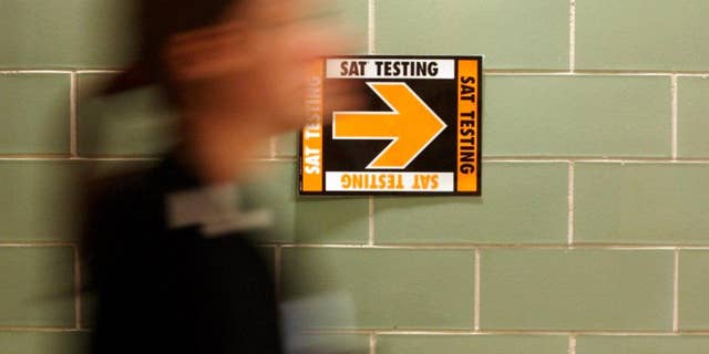 File- This March 12, 2005, file photo shows a student leaving after taking the SAT at Upper Arlington High School in Upper Arlington, Ohio. Student performance on the SAT college entrance exam is lagging, continuing a mostly downward trend over the last five years. The College Board says in a report that a record number of students took the exam. (AP Photo/Paul Vernon, File)