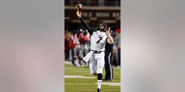 FILE - In this Nov. 23, 2013, file photo, Missouri quarterback Maty Mauk (7) throws downfield to a receiver during pregame drills before their NCAA college football game against Mississippi, in Oxford, Miss. Mauk is one of the SEC’s new starting quarterbacks. (AP Photo/Rogelio V. Solis, File)