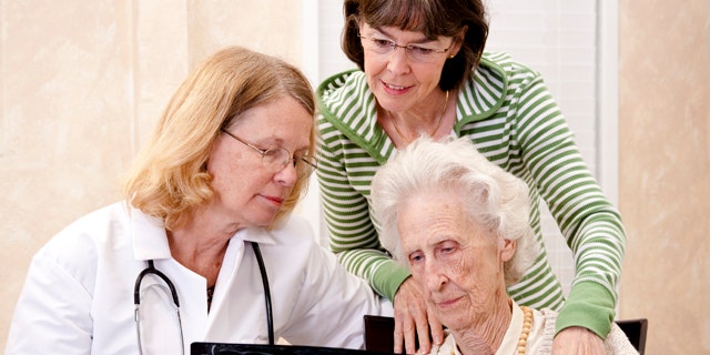 Senior woman visiting with her doctor or caregiver