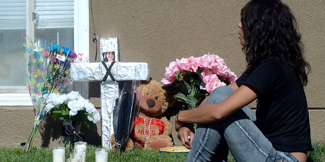 Friends and family mourn at a memorial for sixteen-year-old Jose Izazaga and his 15-year-old sister Abril Izazaga, Thursday, July 7, 2016 in Midvale, Utah. As police search for a man who police say gunned down a teenage brother and sister during an argument over a T-shirt late Wednesday at a Salt Lake City suburb apartment complex, family members are mourning the senseless killing of siblings who shared a tight bond. (Al Hartmann/The Salt Lake Tribune via AP)