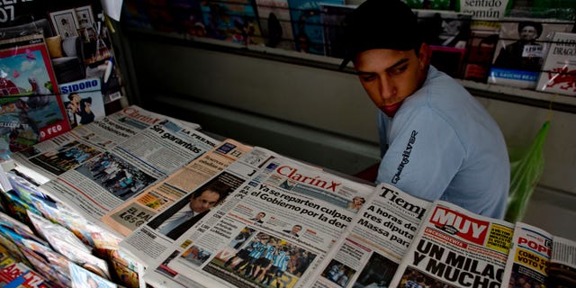 A vendor sits in his newspaper stand in Buenos Aires, Argentina, Tuesday, Oct. 29, 2013.