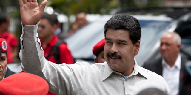 Nicolás Maduro waves during a visit to the Bolivarian National Guard command in Caracas, Venezuela, on Oct. 2, 2013.