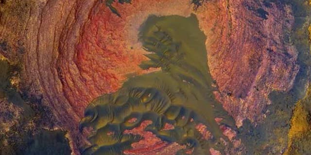 NASA's Mars Reconnaissance Orbiter has captured stunning images of the Red Planet, including some views that look very similar to vistas on Earth like this view of Martian bedrock and sand dunes.