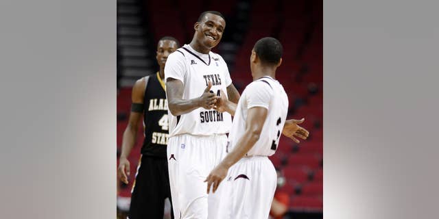 Texas Southern's Aaric Murray (24) celebrates with Madarious Gibbs (3) after Texas Southern defeated Alabama State in an NCAA college basketball game in the semifinals of the Southwestern Athletic Conference men's tournament Friday, March 14, 2014, in Houston. Texas Southern won 73-61. (AP Photo/David J. Phillip)
