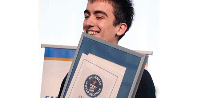 Georgian President Mikhail Saakashvili's son, Eduard, 15, holds a Guinness World Records certificate that he received for setting a new world record for printing the English Alphabet on an iPad in 5,26 seconds with his right hand only. The previous record set up by British Charlie Mcdonnell in 2010 was 6,31 seconds. (AP Photo/Irakli Gedenidze, Pool)