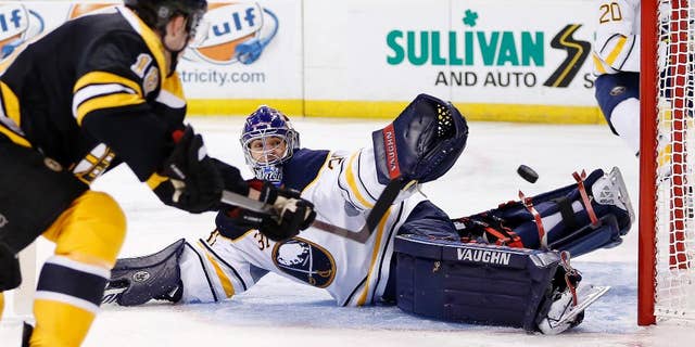 Boston Bruins' Reilly Smith (18) shoots wide of Buffalo Sabres' Matt Hackett (31) during the second period of an NHL hockey game in Boston, Saturday, April 12, 2014. (AP Photo/Michael Dwyer)
