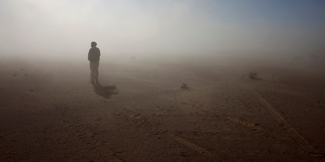 File photo - A Sahrawi man stands in the Sahara desert between Tindouf and Tifariti,