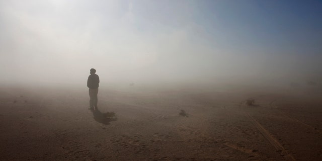 File photo - A Sahrawi man stands in the Sahara desert between Tindouf and Tifariti,