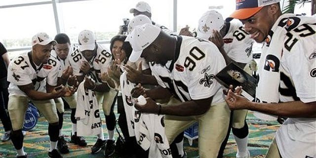 Some of the New Orleans Saints get down at a Super Bowl press conference. (AP)