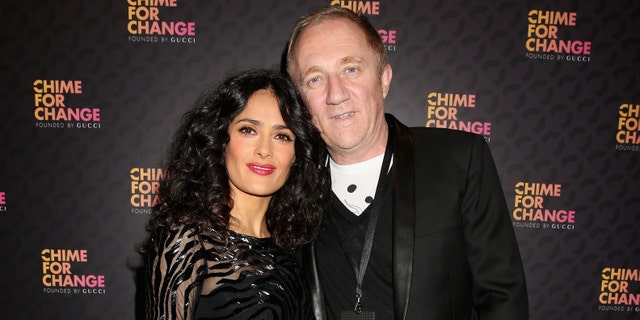 Salma Hayek Pinault and Francois Henri Pinault arrive at the Royal Box photo wall ahead of the "Chime For Change: The Sound Of Change Live" Concert at Twickenham Stadium on June 1, 2013 in London, England.