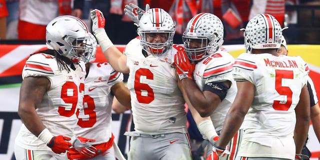 Jan 1, 2016; Glendale, AZ, USA; Ohio State Buckeyes defensive end Sam Hubbard (6) celebrates with teammates after a tackle in the second half against the Notre Dame Fighting Irish during the 2016 Fiesta Bowl at University of Phoenix Stadium. The Buckeyes defeated the Fighting Irish 44-28. Mandatory Credit: Mark J. Rebilas-USA TODAY Sports