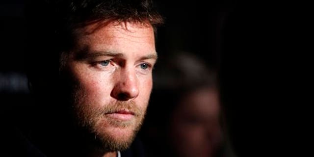 FILE - In this Jan. 19, 2012 file photo, Actor Sam Worthington attends the Cinema Society premiere of "Man on a Ledge" in New York. Police say Worthington has been arrested Sunday, Feb. 23, 2014, in New York City for punching a photographer after the man kicked Worthington's girlfriend in the shin. The Australian actor was released on a desk appearance ticket and is due back in court on Feb. 26. (AP Photo/Peter Kramer, File)