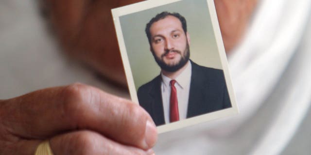 August 16: Wajeeha Allawi, 76, mother of Al-Jazeera reporter Samer Allawi holds a picture of her son inside her home in the West Bank city of Nablus. Israel has arrested the Palestinian journalist who works for the Arabic language Al-Jazeera satellite network. A journalists' advocacy group says he is being held without charges.