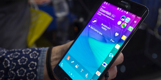 A woman holds a Samsung Galaxy Edge smartphone during the 2015 International Consumer Electronics Show (CES) in Las Vegas, Nevada Jan. 6, 2015.